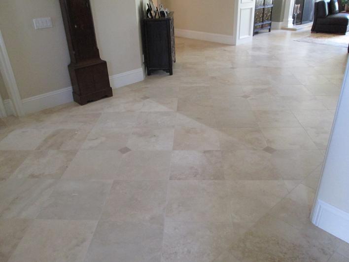 PHOTO IMAGE OF BEFORE CLEANING & RESEALING TRAVERTINE TILE FLOOR.
